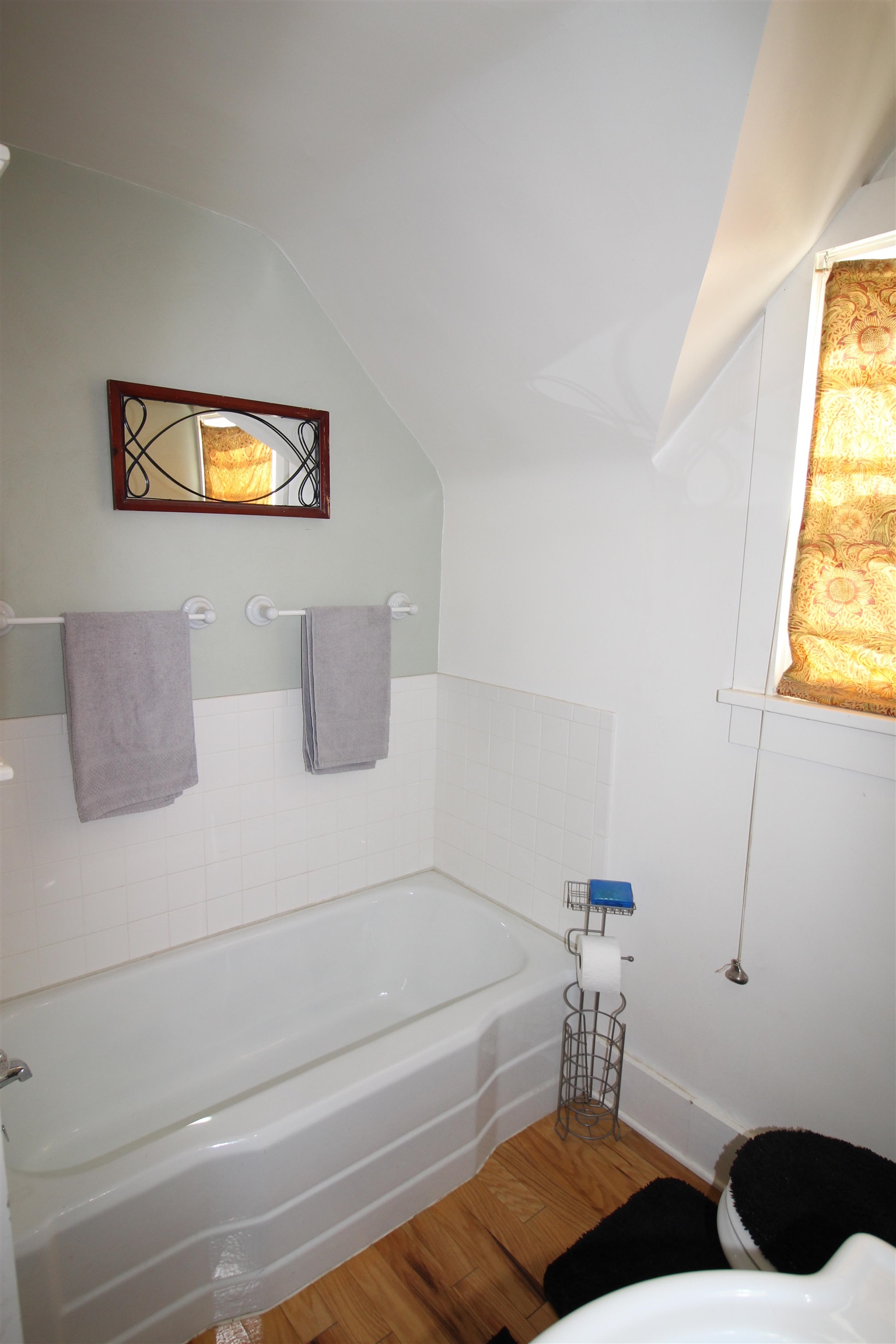 1150 East 7th Street Delta, CO 81416 - Photo 21 of 32 a bathroom with a bathtub and a window