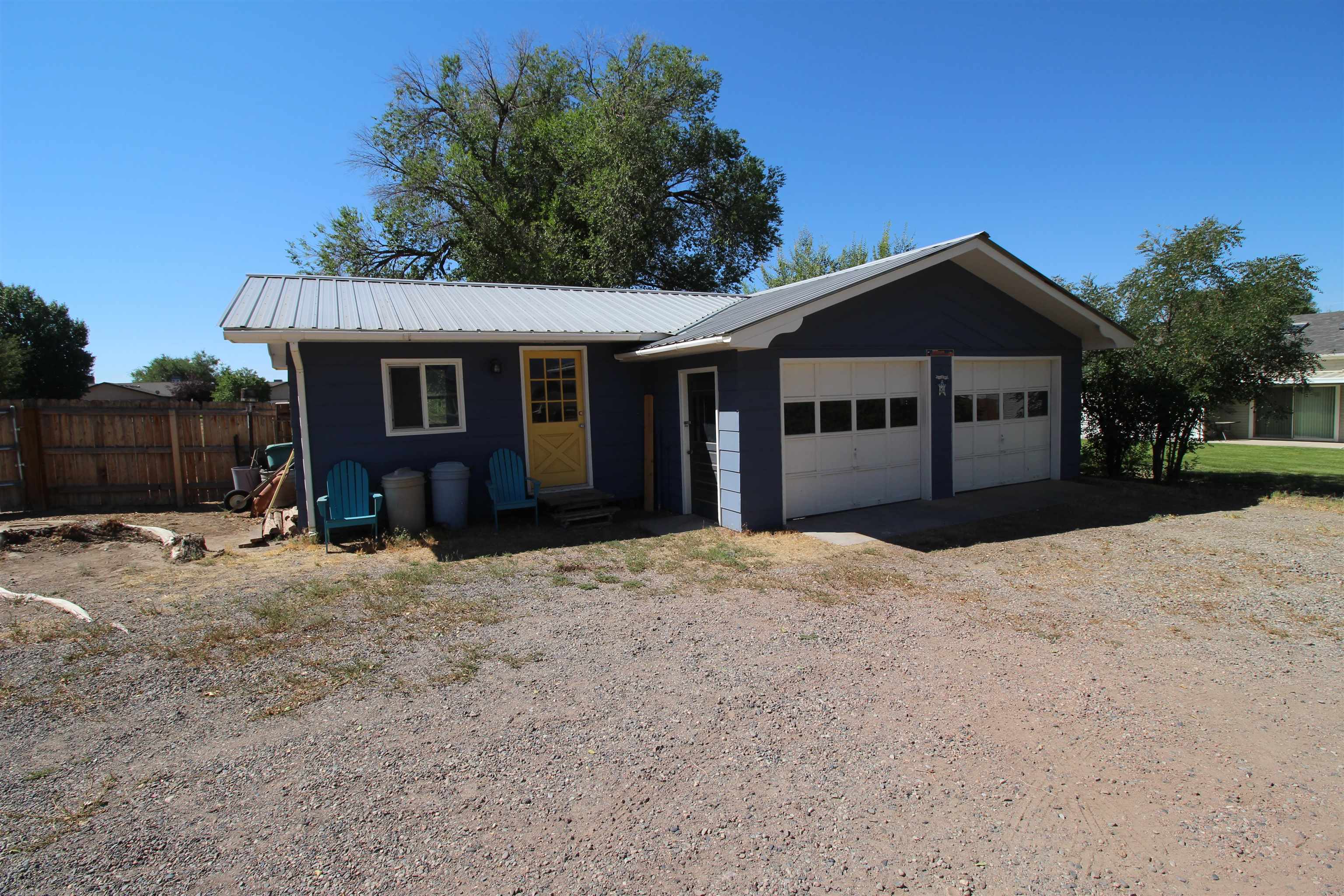 1150 East 7th Street Delta, CO 81416 - Photo 26 of 32 a front view of a house with a yard and garage