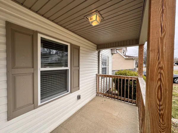a view of a porch with wooden floor and fence