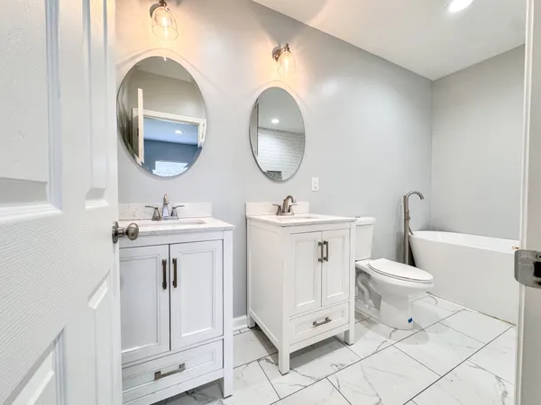 a bathroom with a toilet sink and mirror