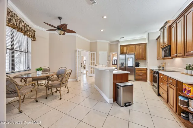 a living room with patio furniture and a floor to ceiling window