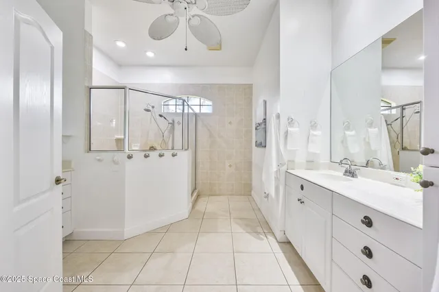 a bathroom with a double vanity sink mirror and shower