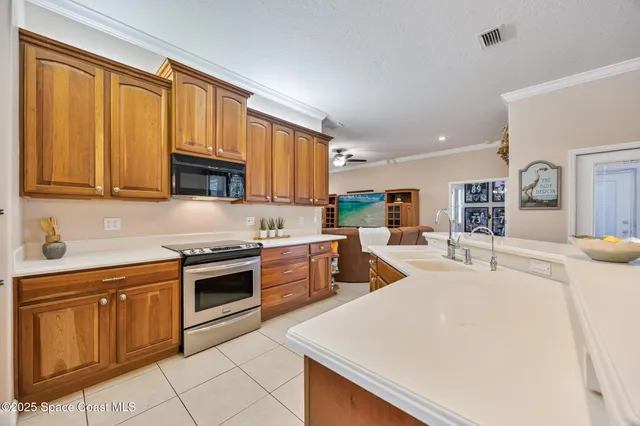 a kitchen with stainless steel appliances granite countertop a sink a stove and cabinets