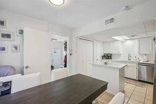 a kitchen with white cabinets and white appliances