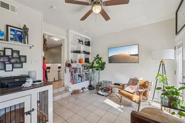 a living room with furniture and a potted plant