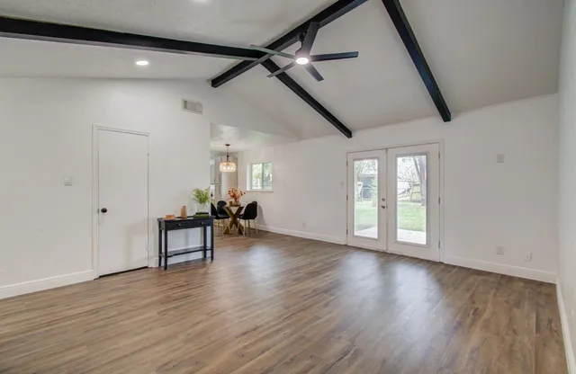 wooden floor in an empty room with a window
