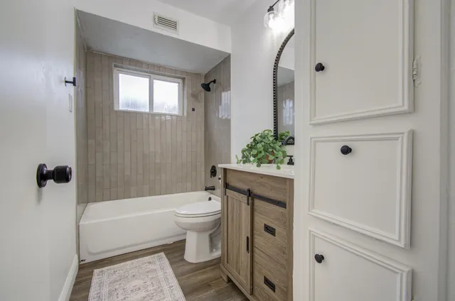 a bathroom with a toilet a sink and bathtub