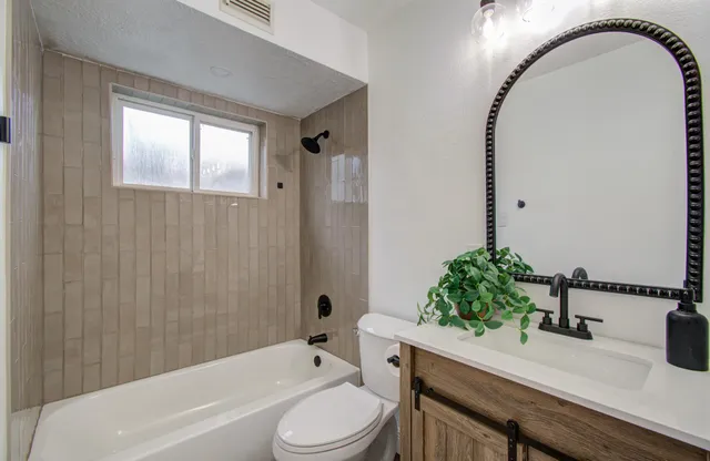 a bathroom with a sink a toilet and tub