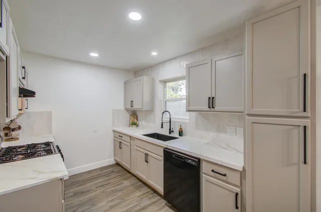 a kitchen with a sink stove and cabinets