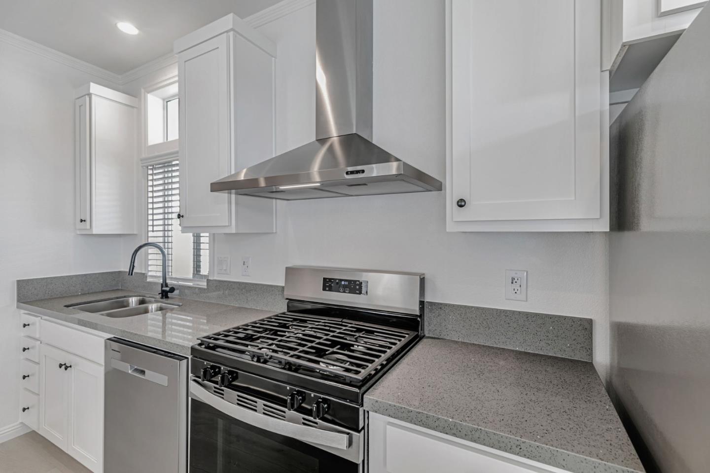 555 Umbarger Road, Unit 131 San Jose, CA 95111 - Photo 12 of 32 a kitchen with granite countertop a sink stove and cabinets