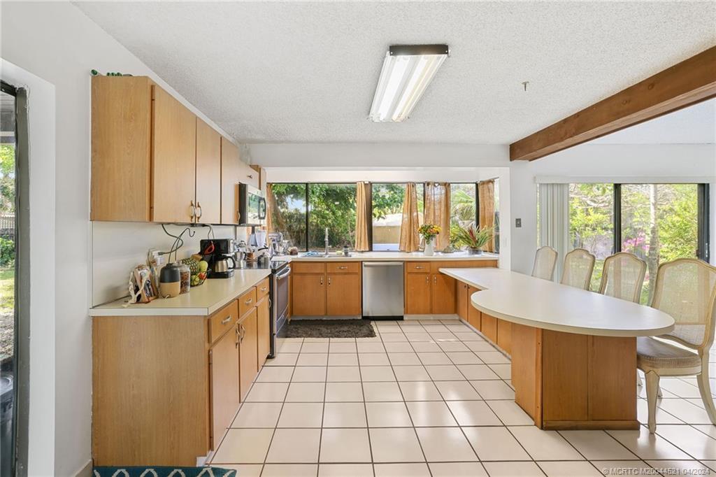 12775 Southwest 110th Terrace Miami, FL 33186 - Photo 14 of 36 a large white kitchen with a large window