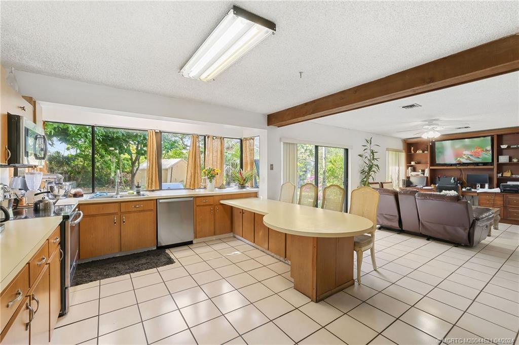 12775 Southwest 110th Terrace Miami, FL 33186 - Photo 15 of 36 a large white kitchen with a large window and counter space