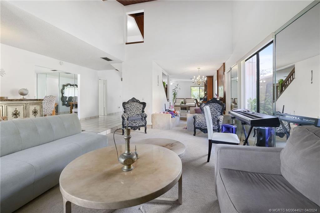 12775 Southwest 110th Terrace Miami, FL 33186 - Photo 2 of 36 a living room with furniture and a chandelier