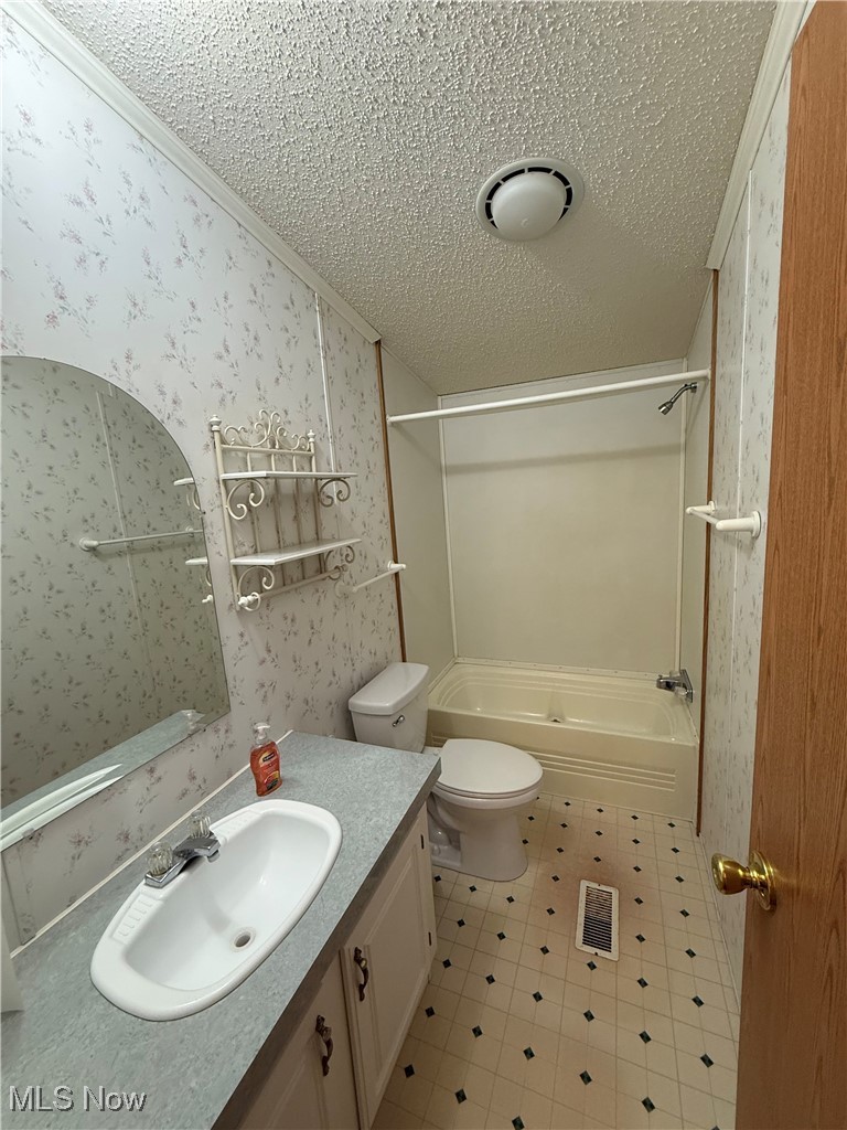18592 Edwards Road, Unit 137 Doylestown, OH 44230 - Photo 16 of 17 Unfurnished bedroom featuring lofted ceiling, a closet, carpet, a textured ceiling, and a ceiling fan
