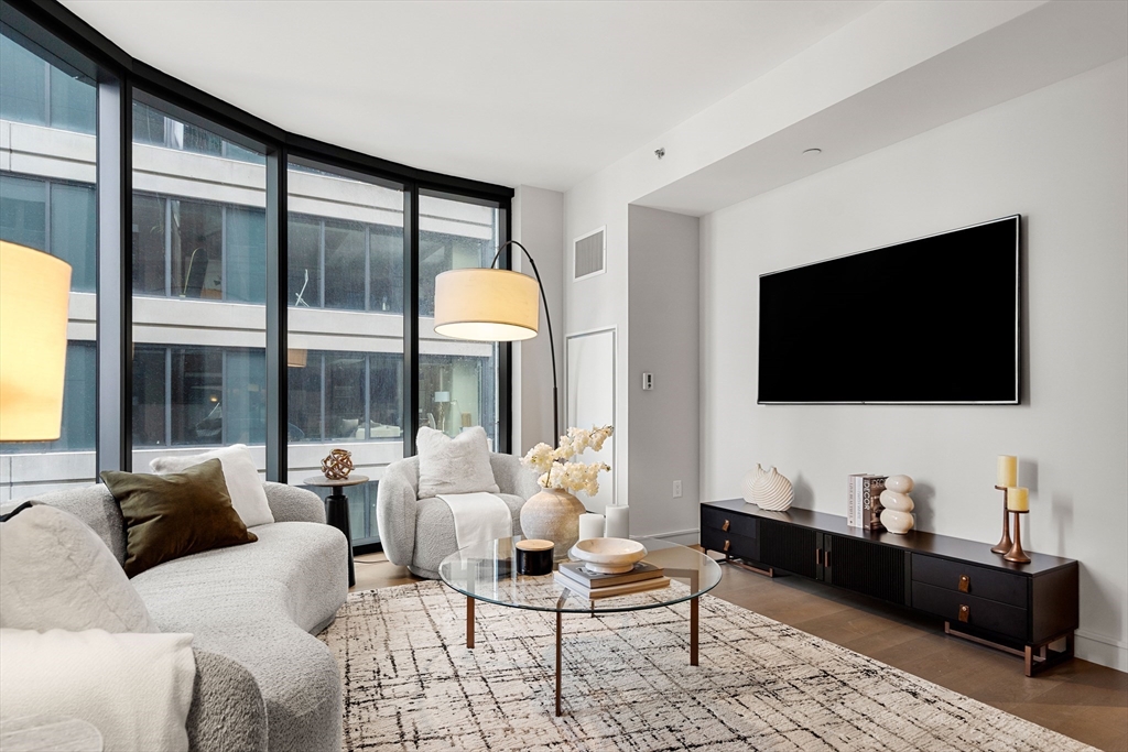 55 Lagrange Street, Unit 1901 Boston, MA 02111 - Photo 11 of 34 a living room with furniture and a flat screen tv
