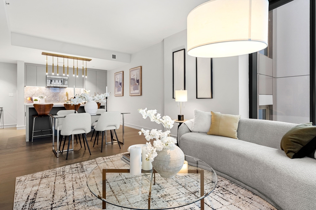 55 Lagrange Street, Unit 1901 Boston, MA 02111 - Photo 12 of 34 a living room with furniture and a chandelier