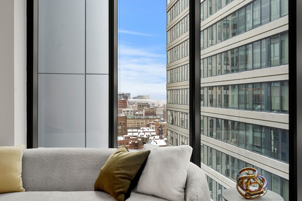 55 Lagrange Street, Unit 1901 Boston, MA 02111 - Photo 14 of 34 a living room with furniture and a window