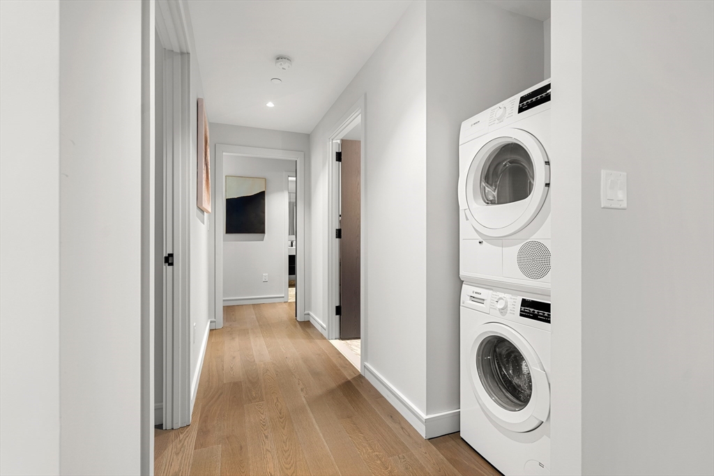 55 Lagrange Street, Unit 1901 Boston, MA 02111 - Photo 15 of 34 a view of a hallway with washer and dryer