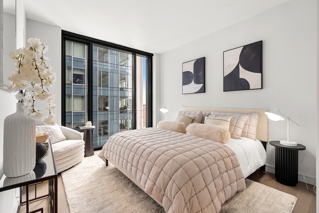 55 Lagrange Street, Unit 1901 Boston, MA 02111 - Photo 16 of 34 a bedroom with a large bed and a window