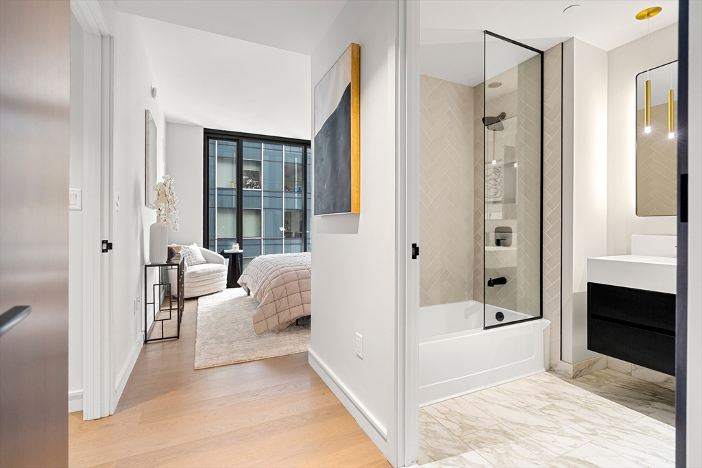 55 Lagrange Street, Unit 1901 Boston, MA 02111 - Photo 18 of 34 a bathroom with a tub shower and sink