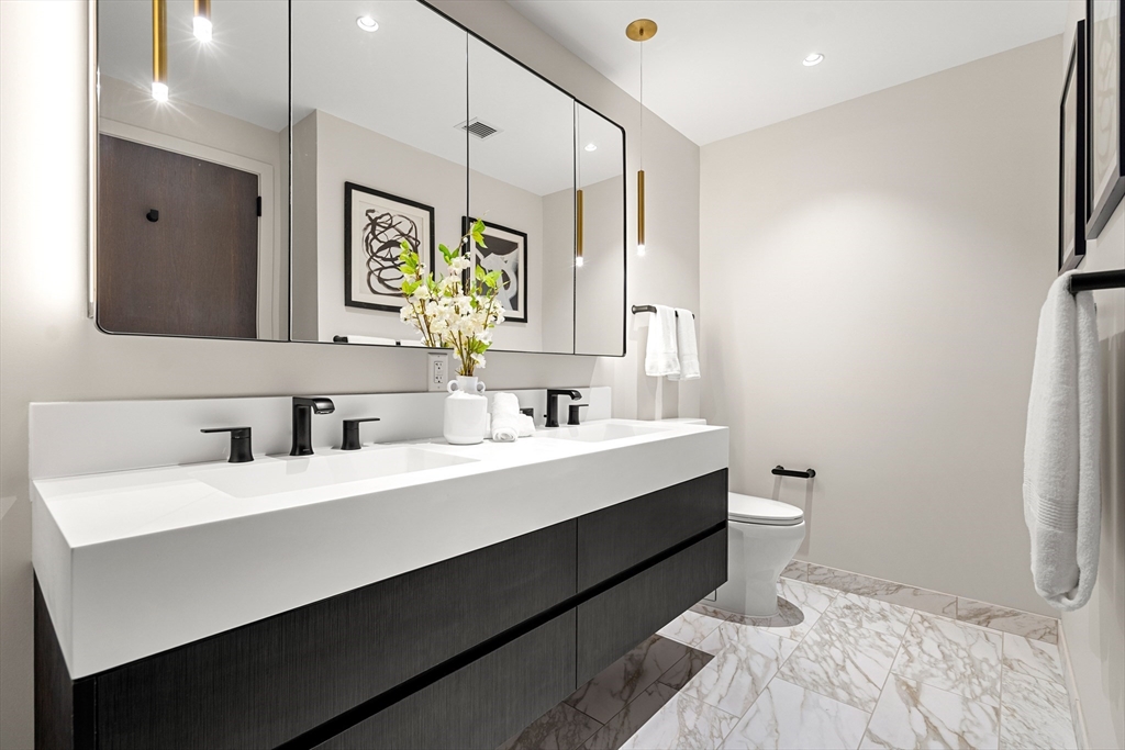 55 Lagrange Street, Unit 1901 Boston, MA 02111 - Photo 19 of 34 a bathroom with a sink double vanity and a mirror