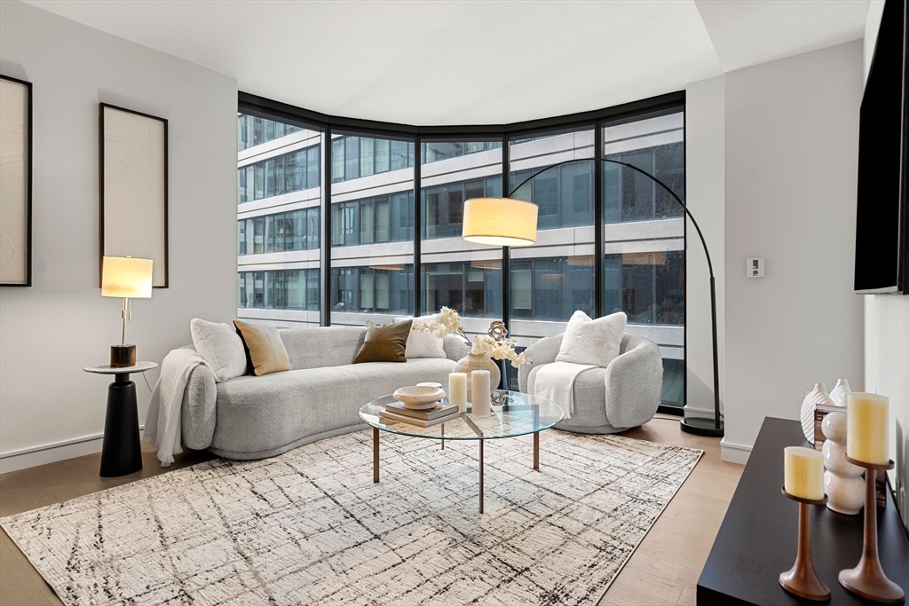 55 Lagrange Street, Unit 1901 Boston, MA 02111 - Photo 2 of 34 a living room with furniture