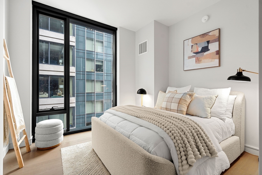 55 Lagrange Street, Unit 1901 Boston, MA 02111 - Photo 21 of 34 a bedroom with a large bed and a large window