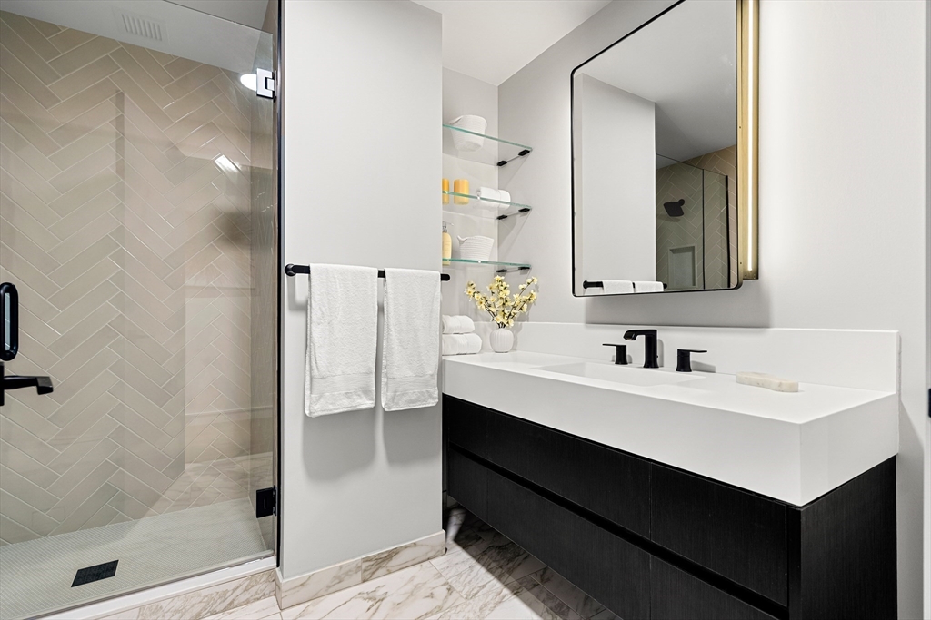 55 Lagrange Street, Unit 1901 Boston, MA 02111 - Photo 22 of 34 a bathroom with a sink double vanity and a mirror