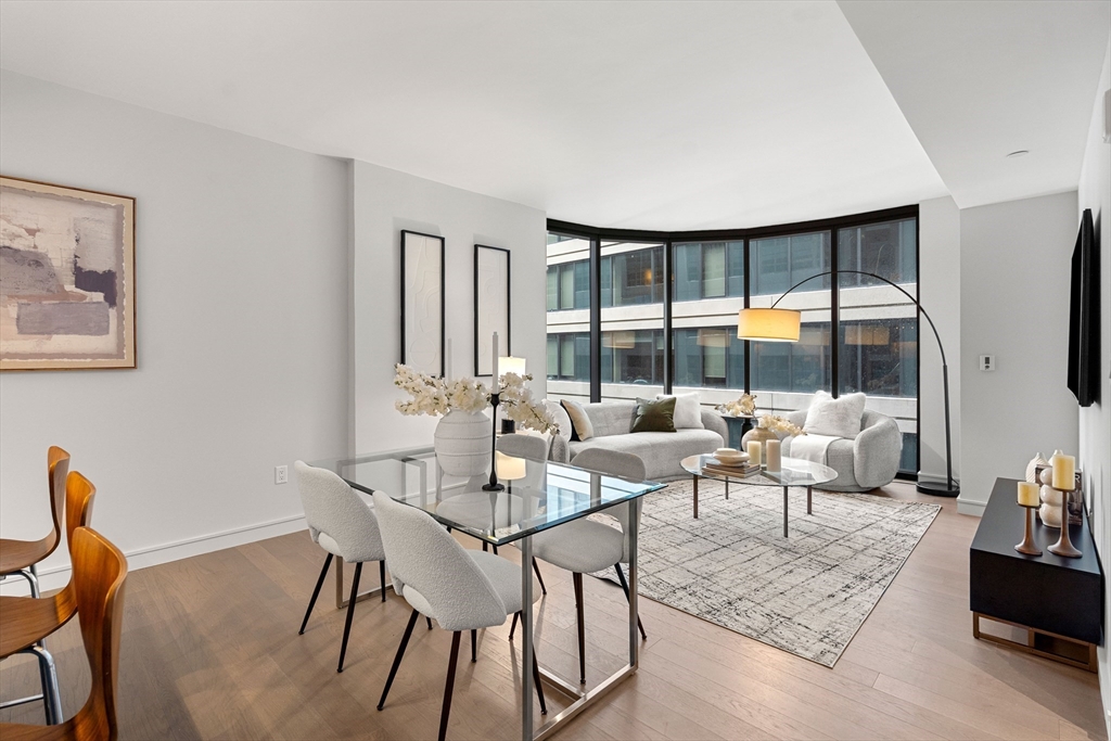55 Lagrange Street, Unit 1901 Boston, MA 02111 - Photo 3 of 34 a living room with furniture and a large window