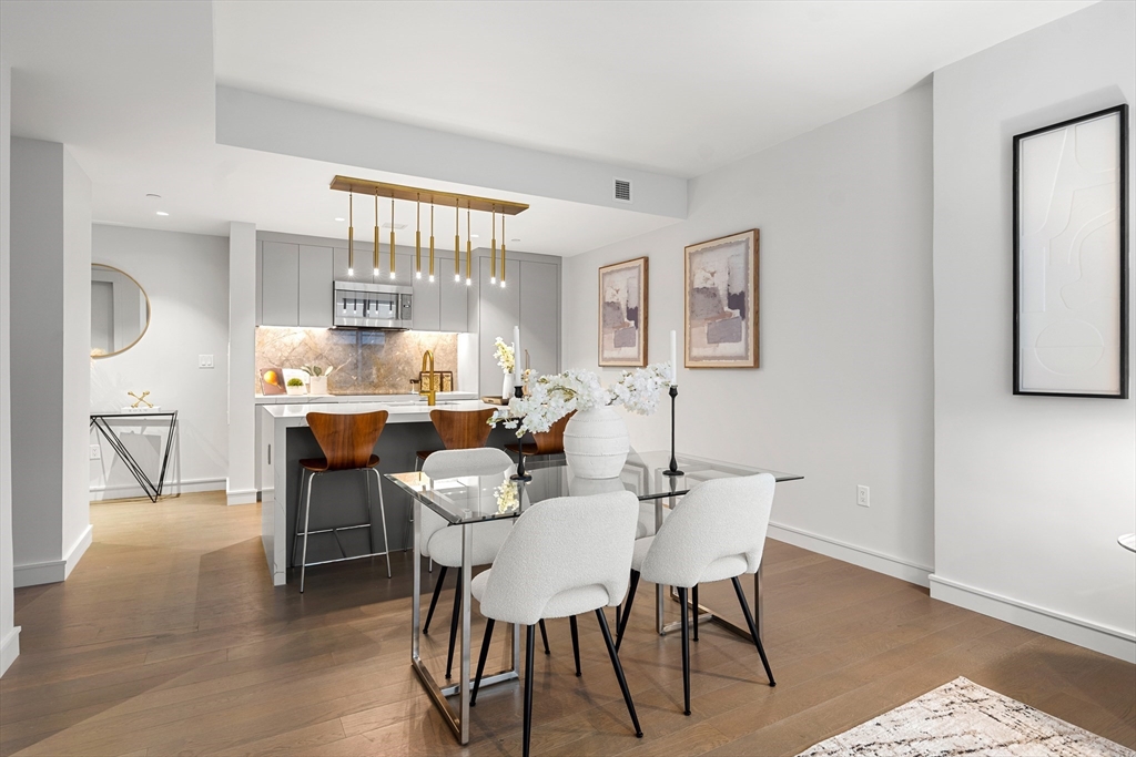 55 Lagrange Street, Unit 1901 Boston, MA 02111 - Photo 4 of 34 a view of a dining room with furniture and a large window