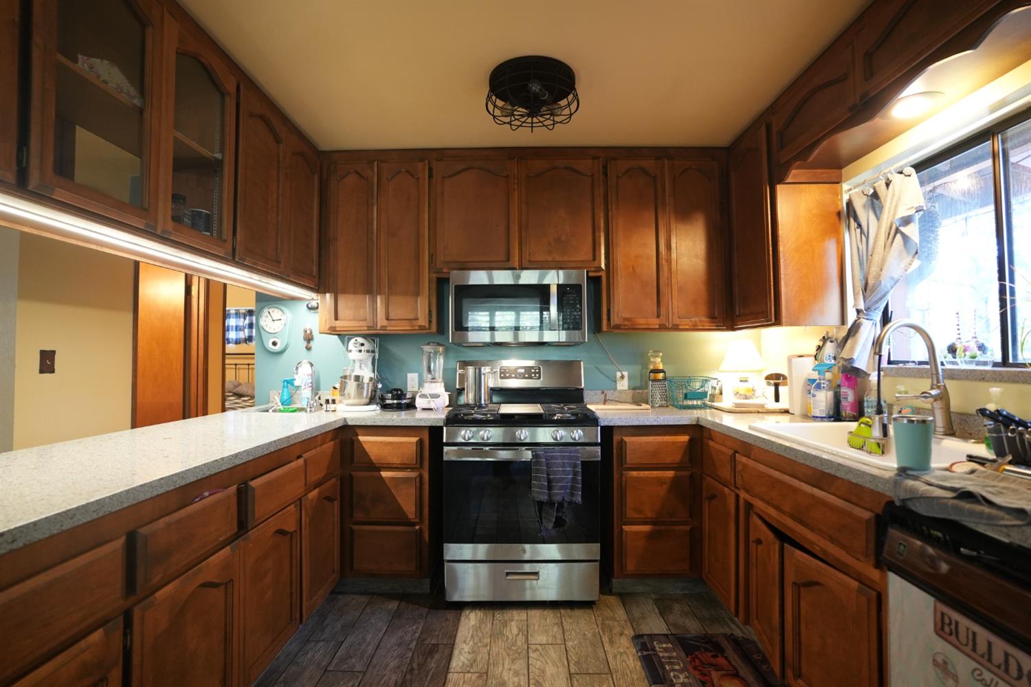 23625 Rock Hammer Road Groveland, CA 95321 - Photo 13 of 40 a kitchen with stainless steel appliances granite countertop a stove a sink dishwasher and a microwave oven with cabinets