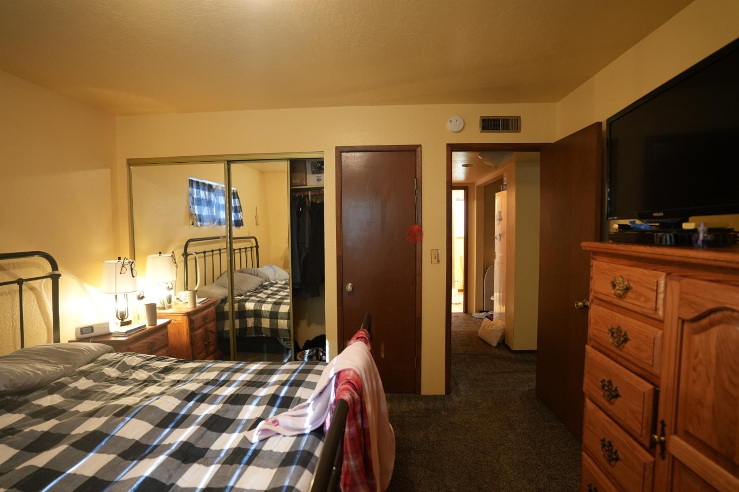 23625 Rock Hammer Road Groveland, CA 95321 - Photo 17 of 40 a bedroom with a bed and a flat tv screen on dresser