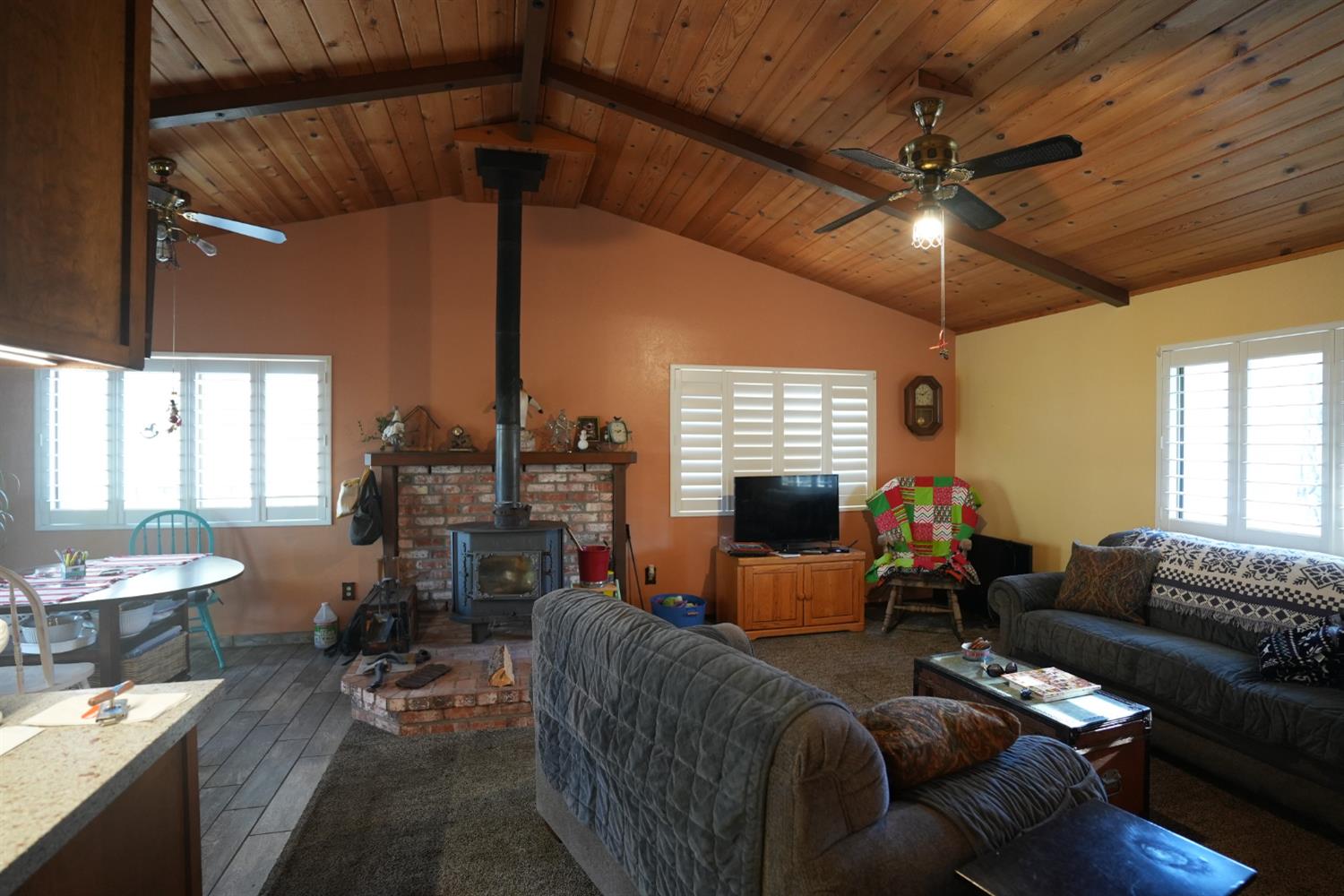 23625 Rock Hammer Road Groveland, CA 95321 - Photo 5 of 40 a living room with furniture a fireplace and a flat screen tv