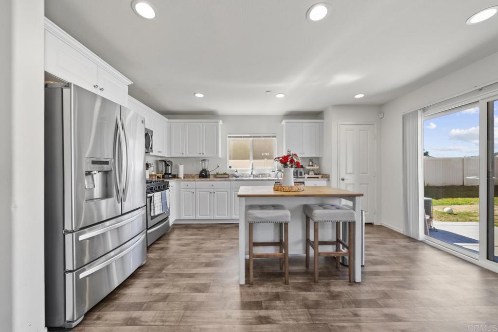 29483 Beeler Road Winchester, CA 92596 - Photo 12 of 42 a kitchen with white cabinets and stainless steel appliances