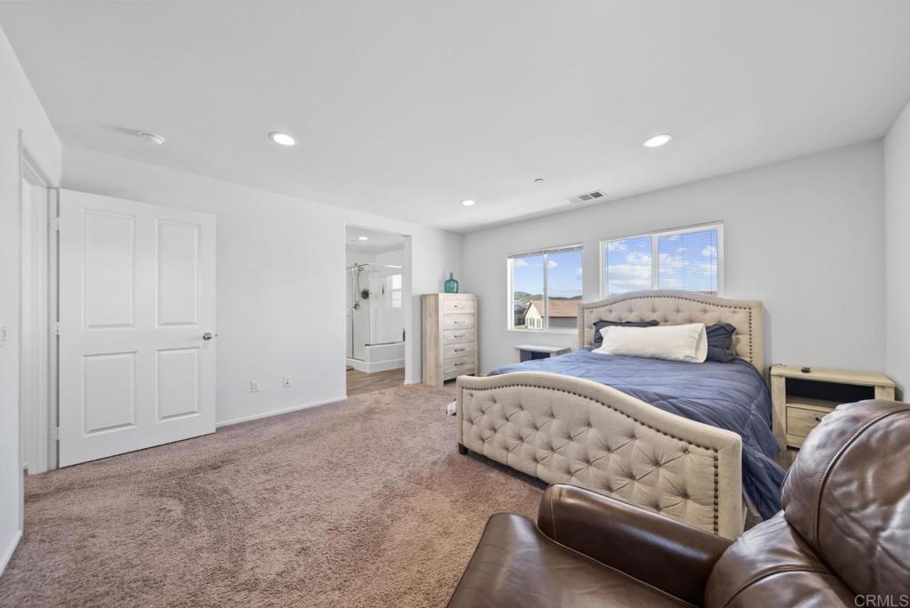 29483 Beeler Road Winchester, CA 92596 - Photo 13 of 42 a spacious bedroom with a bed and a couch