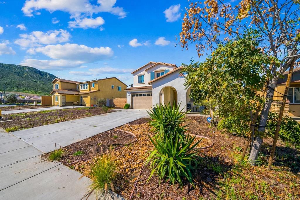 29483 Beeler Road Winchester, CA 92596 - Photo 28 of 42 a front view of a house with a yard and potted plants