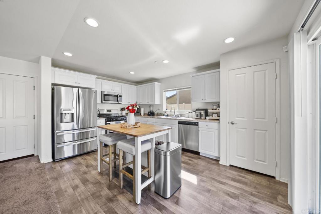 29483 Beeler Road Winchester, CA 92596 - Photo 4 of 42 a kitchen with cabinets and wooden floor