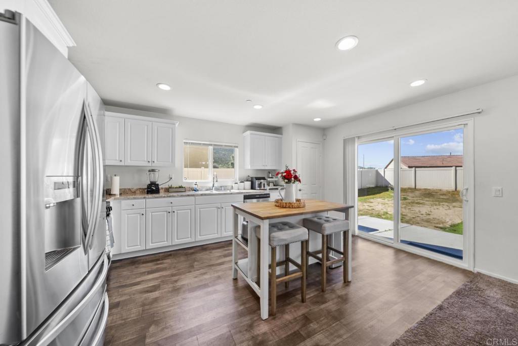 29483 Beeler Road Winchester, CA 92596 - Photo 5 of 42 a kitchen with granite countertop stainless steel appliances a dining table and chairs