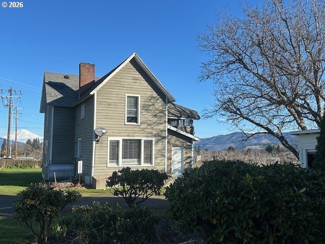 1745 Winston Road Hood River, OR 97031 - Photo 6 of 15 a front view of a house with a yard and mountain view in back