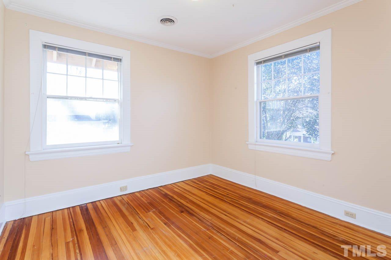 304 Hillcrest Road Raleigh, NC 27605 - Photo 14 of 22 a view of an empty room with wooden floor and a window