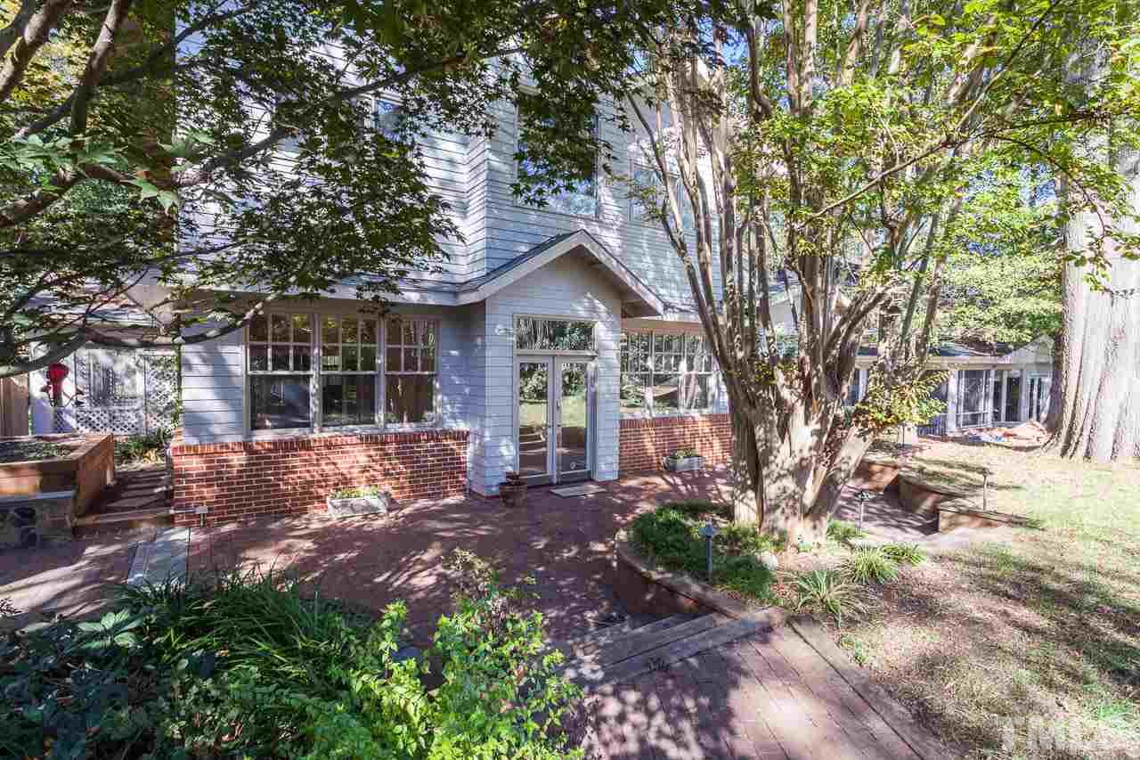 304 Hillcrest Road Raleigh, NC 27605 - Photo 22 of 22 a front view of a house with a garden