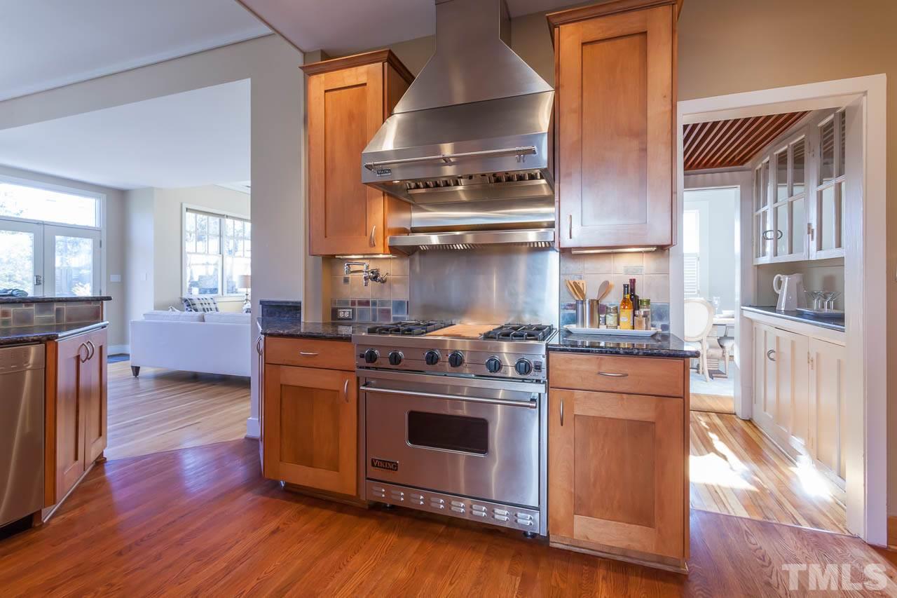 304 Hillcrest Road Raleigh, NC 27605 - Photo 8 of 22 a kitchen with stainless steel appliances granite countertop a stove and a refrigerator