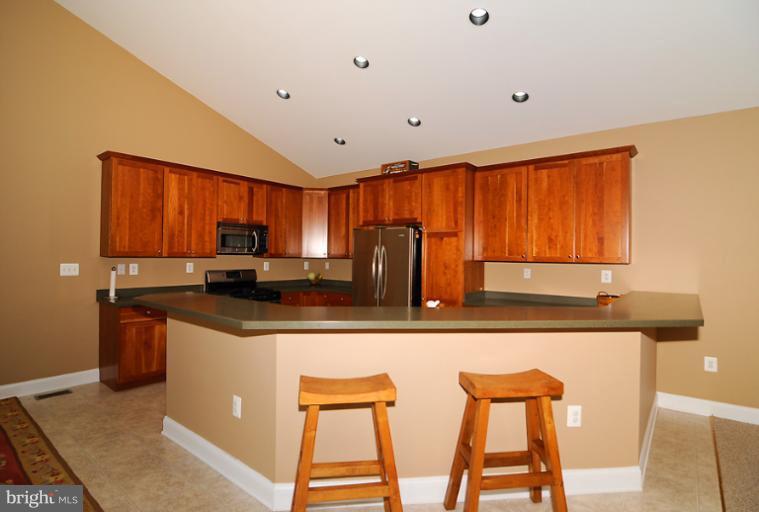 14441 Black Ankle Road Mount Airy, MD 21771 - Photo 14 of 25 a kitchen with stainless steel appliances granite countertop a sink and a refrigerator