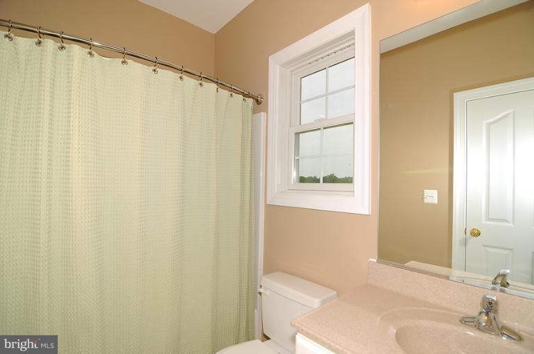 14441 Black Ankle Road Mount Airy, MD 21771 - Photo 22 of 25 a bathroom with a shower curtain and a sink
