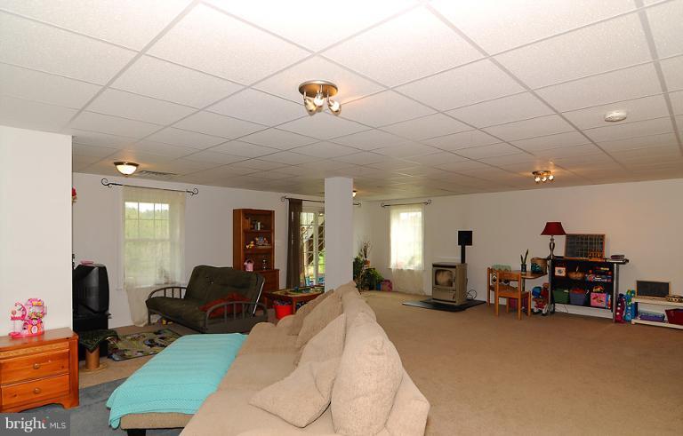14441 Black Ankle Road Mount Airy, MD 21771 - Photo 23 of 25 a view of a livingroom with furniture a flat screen tv and a couch