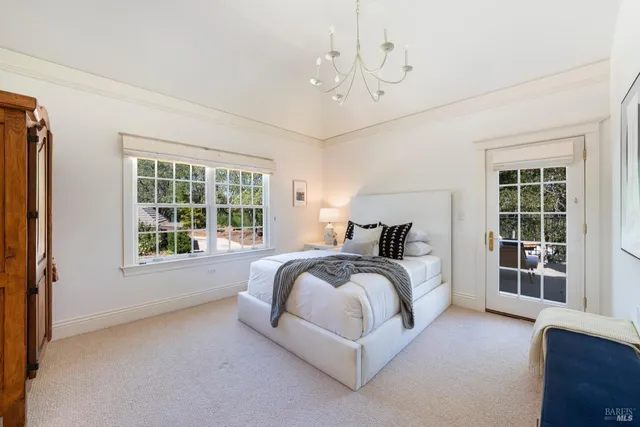 a spacious bedroom with a large bed and a window