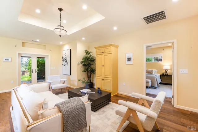 a living room with furniture and a chandelier