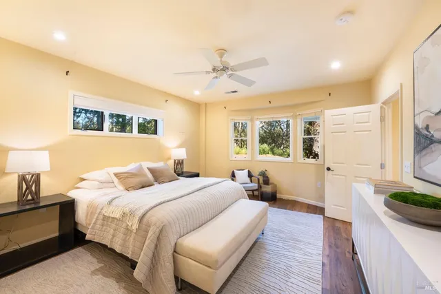 a bedroom with a large bed and a window