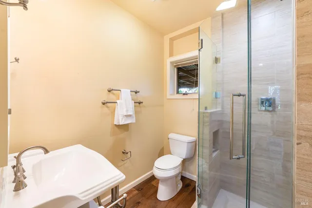 a bathroom with a toilet sink and shower