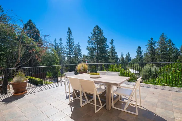 a view of a table and chairs on the roof deck